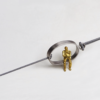 Gray Man Sitting On Gray String Bracelet In A Circle